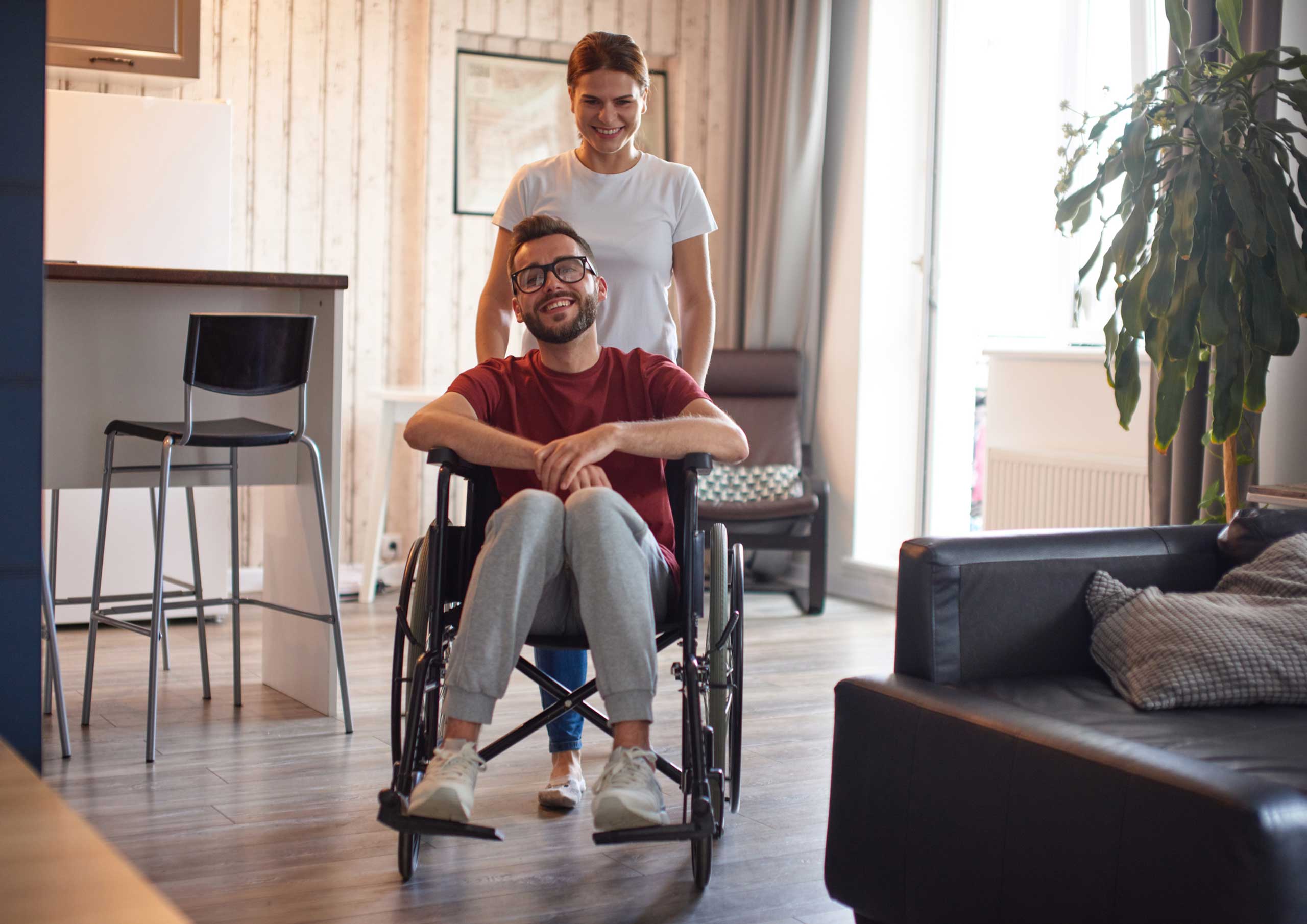 a woman pushing a man in a wheelchair